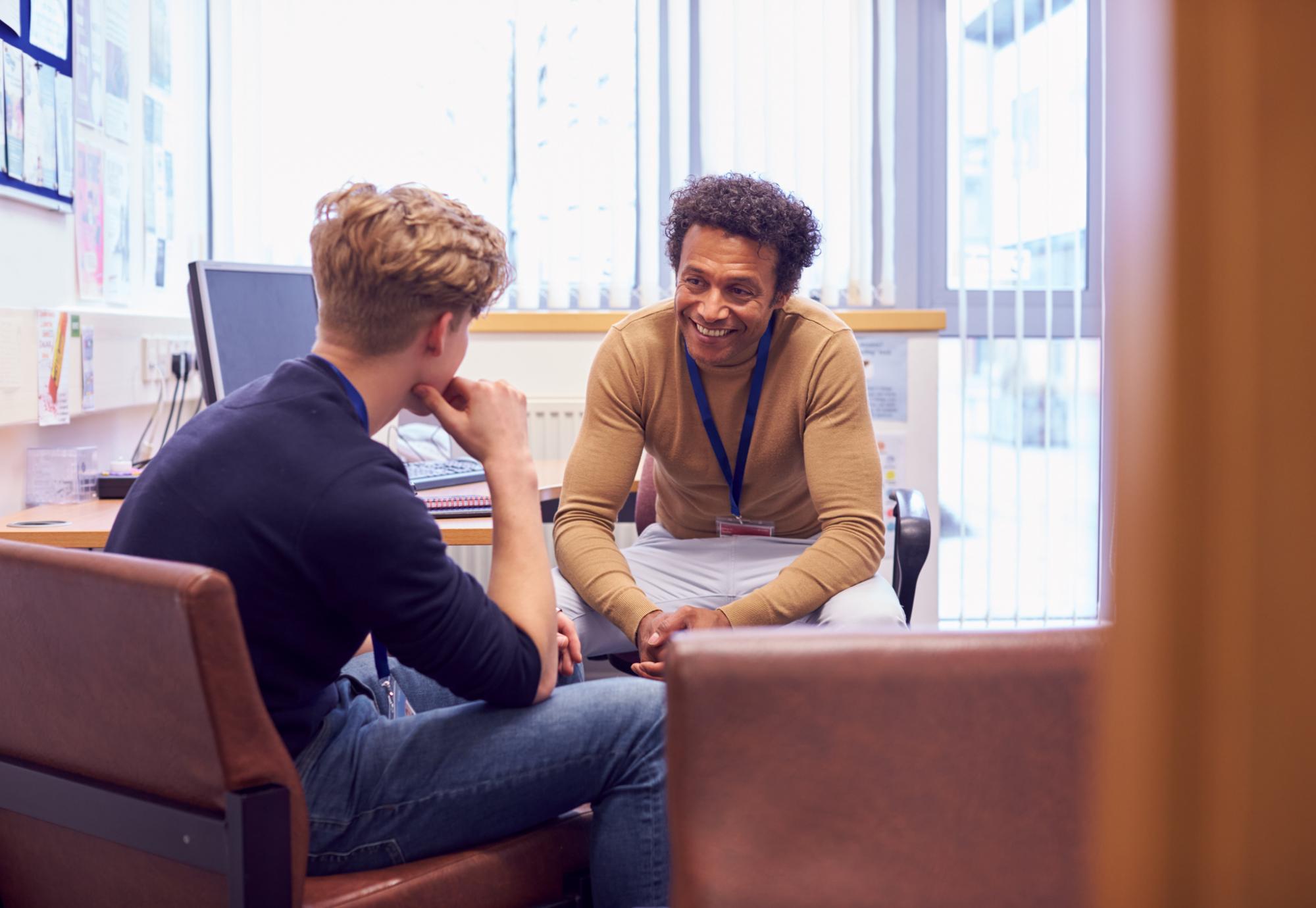 Counsellor talking with young male about his mental health