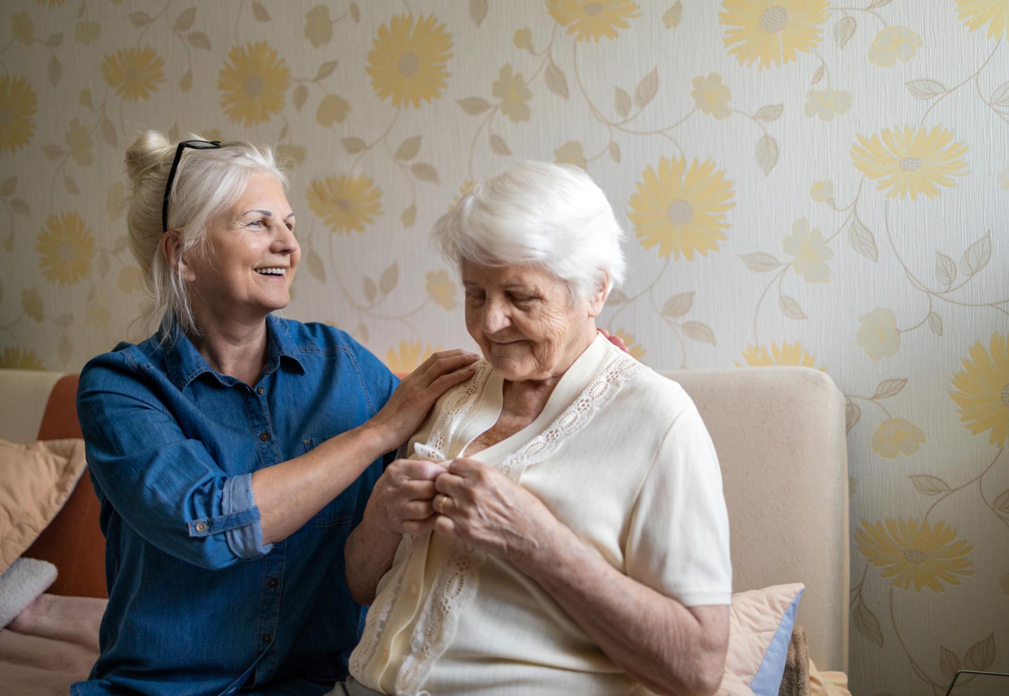 Woman helping elderly family member as an informal carer