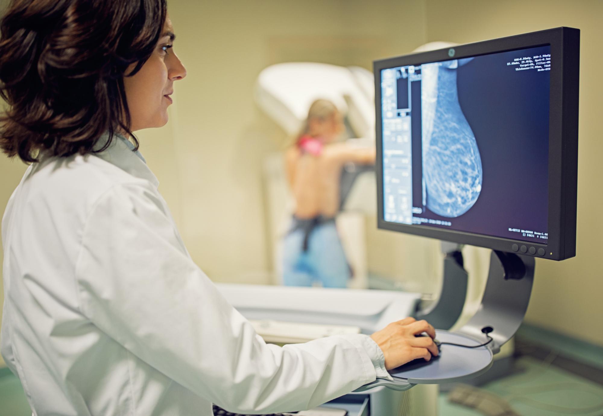Doctor working with mammography X-ray scanner in hospital