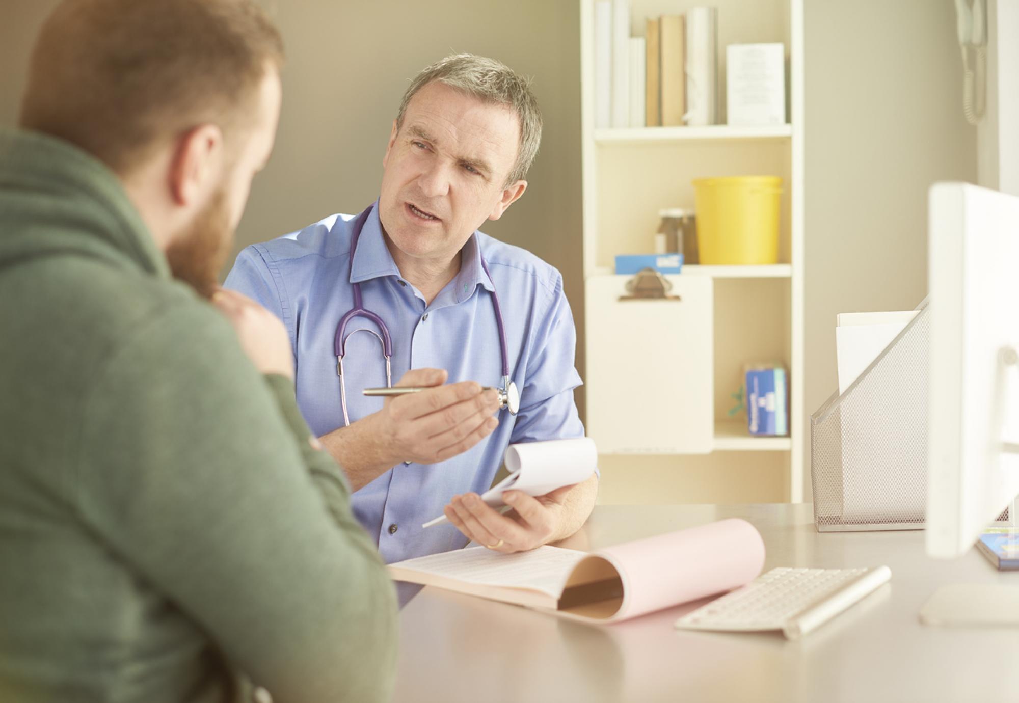 Doctor consulting man about patient safety