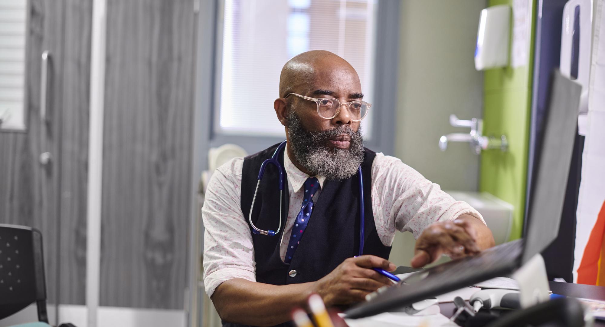 male gp working on a computer