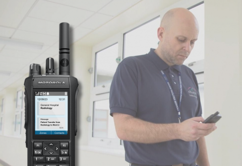 Image of a man holding a digital two-way radio