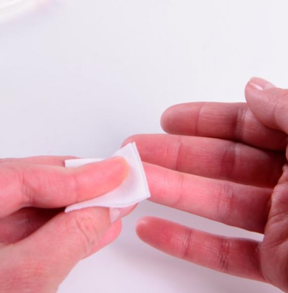 A person holding tissue on their finger 