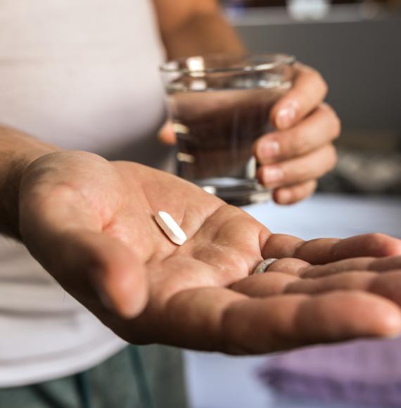 Antibiotic tablet in a man's hand