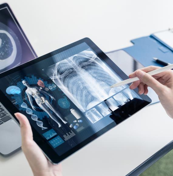 Medical professional using AI/digital solution on tablet and PC