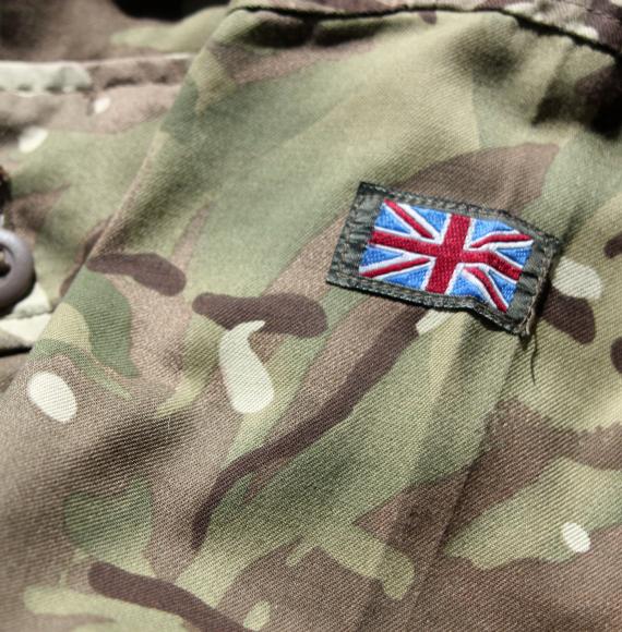 Close up photograph of British military uniform with stitched Union Jack flag