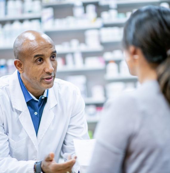 Pharmacist discussing with a customer