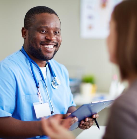 Male nurse holding a clipboard and having a conversation