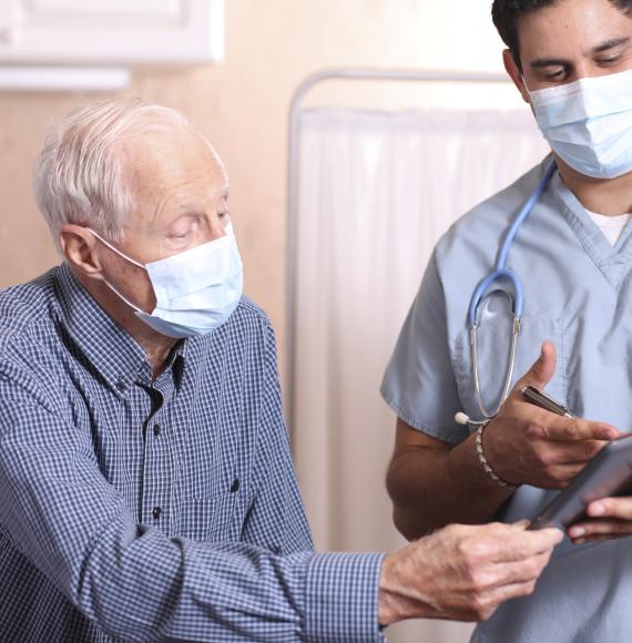 Elderly patient talking with a hospital clinician