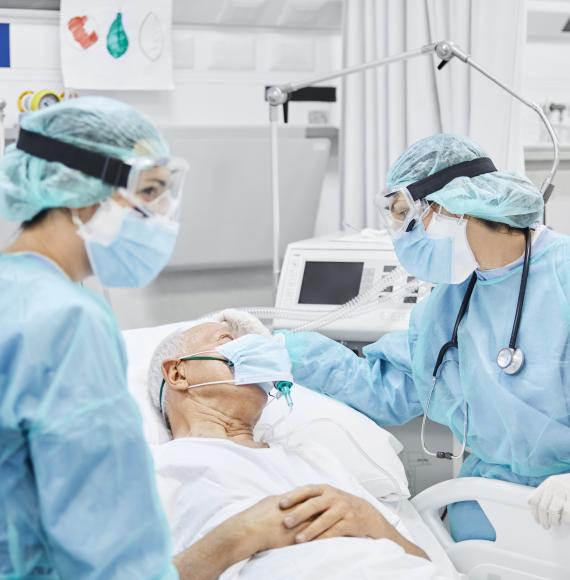 Medical professionals talking to a Covid patient