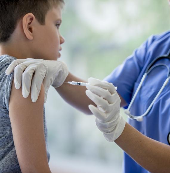 Child receiving a vaccine jab