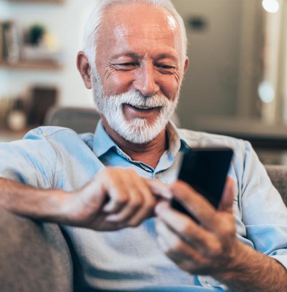 Older man using a phone to read a text message