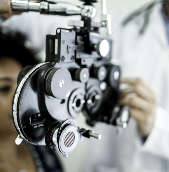 Woman being treated by an ophthalmologist using specialist equipment