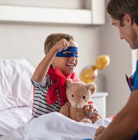Child dressed as a superhero in hospital