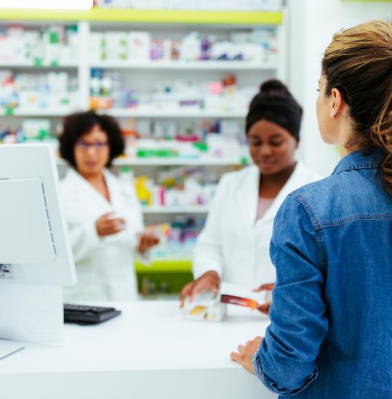 Young woman talking to pharmacists