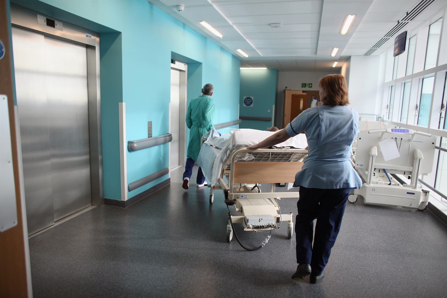 A patient is taken to the operating theatre in the recently opened Birmingham Queen Elizabeth Hospital on February 7, 2011