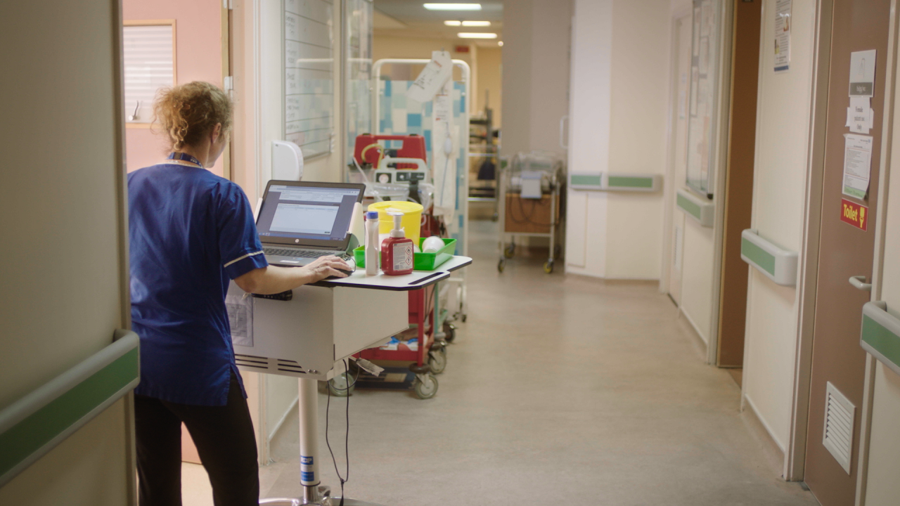 Hospital worker pushing a medical trolley