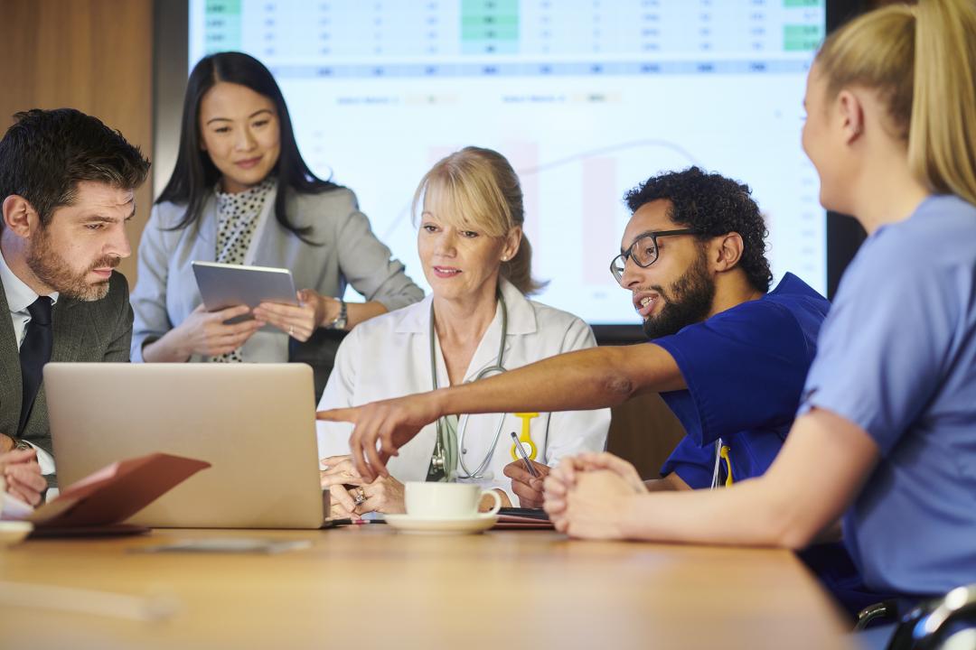 Medical professional pointing something in a meeting