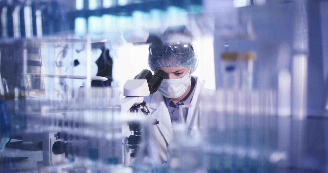 Lab technician working at equipment