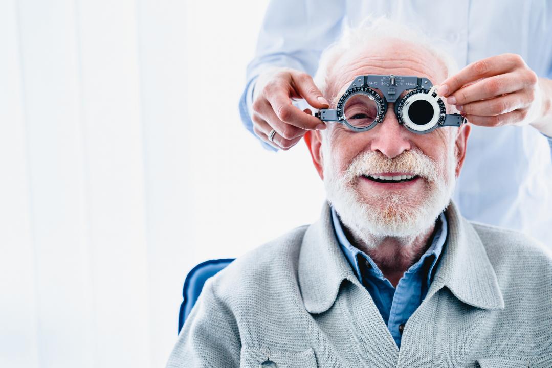 Elderly gentleman having eye equipment placed on his face