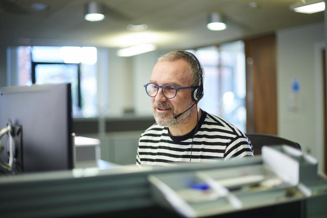 IT worker using a headset at his desk