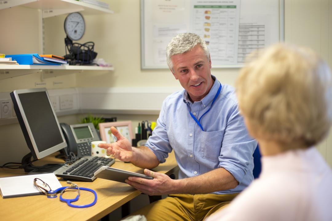 GP talking to a patient at a practice