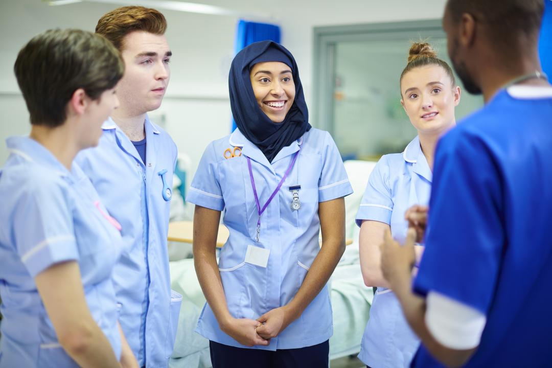 Young trainee NHS staff learning on a ward round