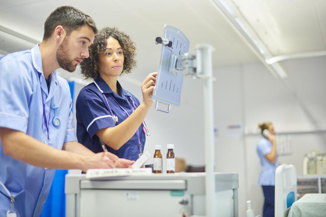 Nursing staff using a digital tablet to administer medicines