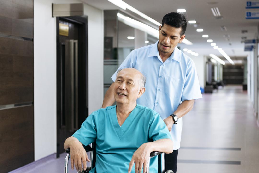 Patient being transferred by a porter