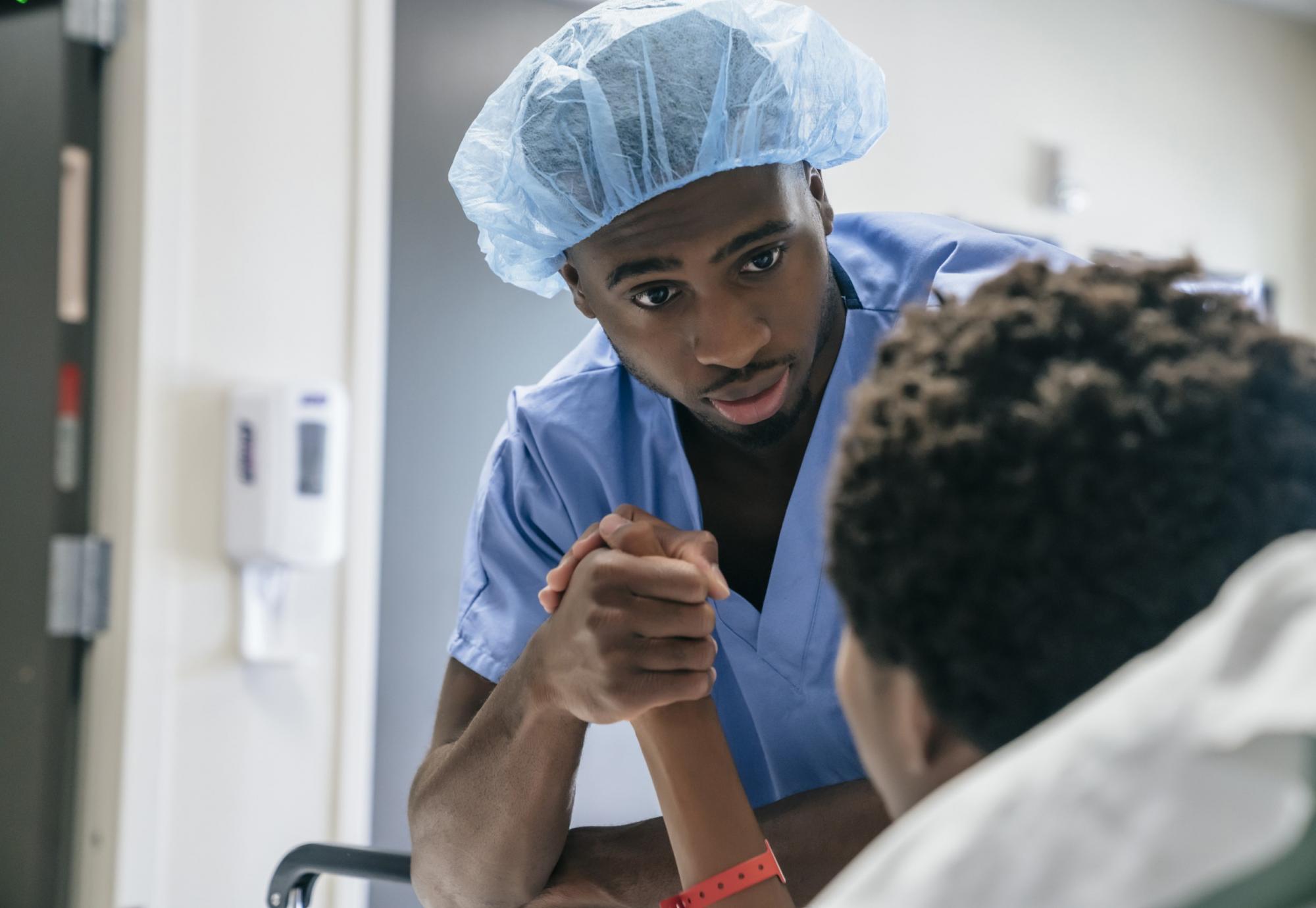 Male nurse attending to patient