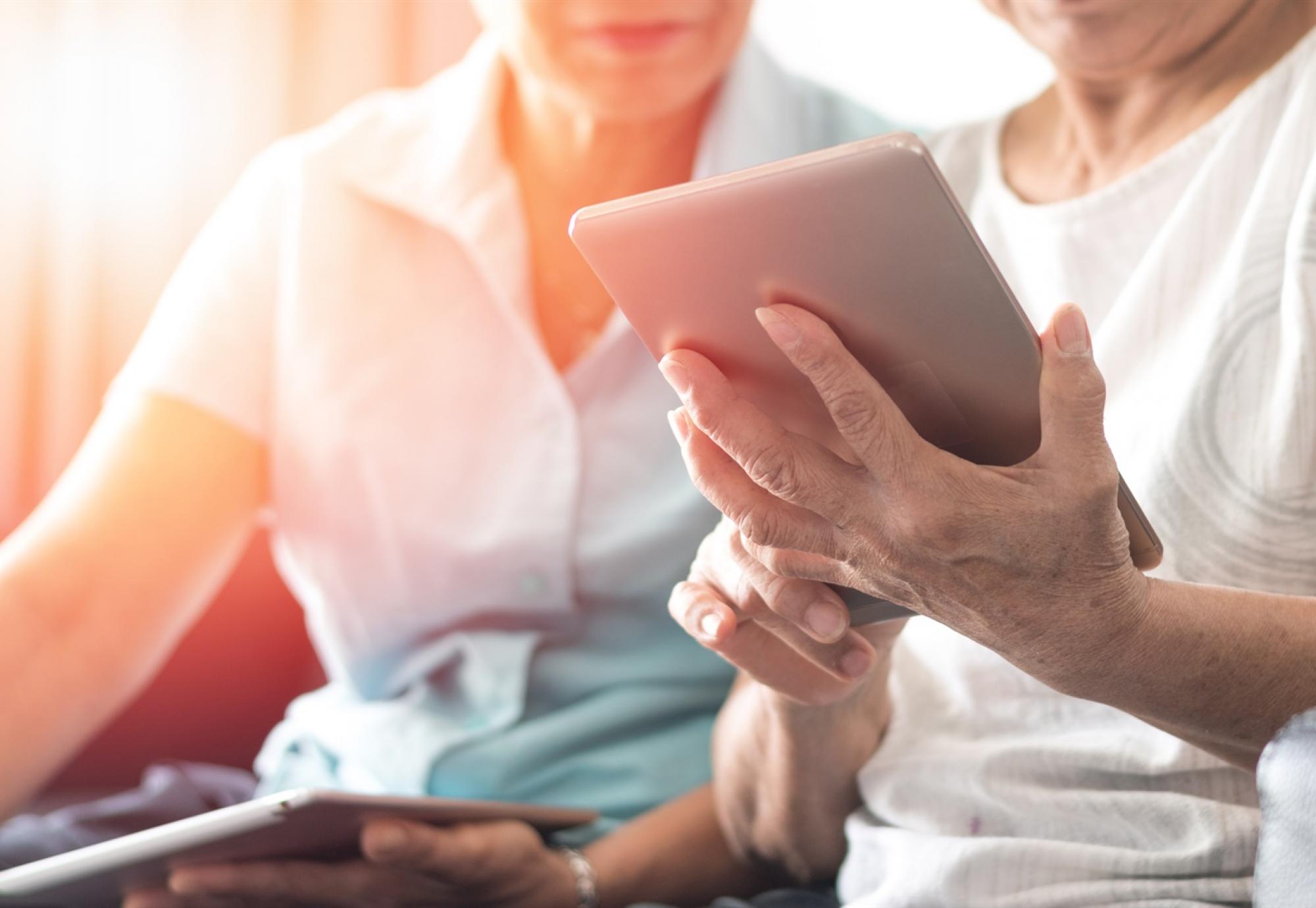 Two people using a tablet PC