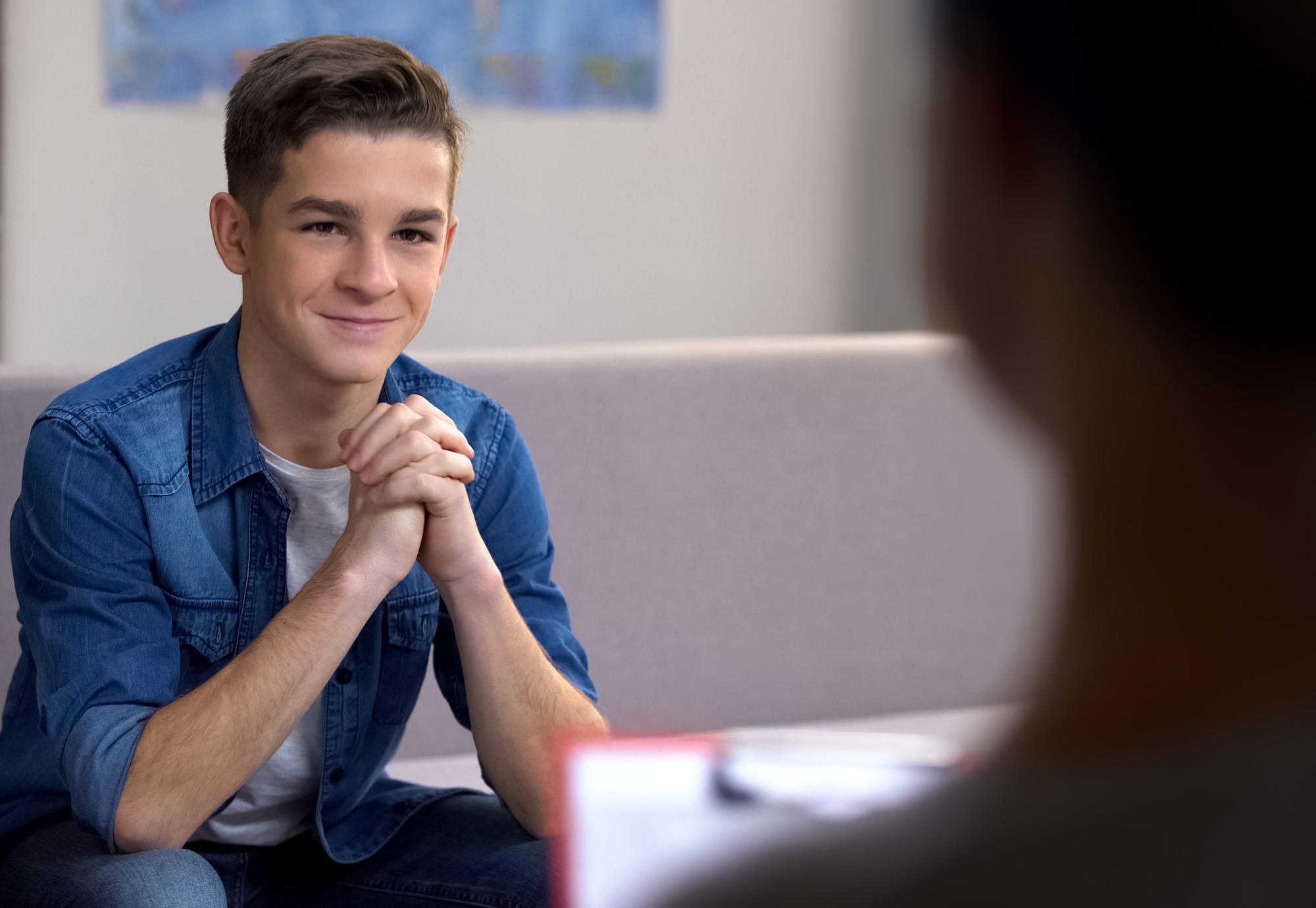 Young man on sofa discussing