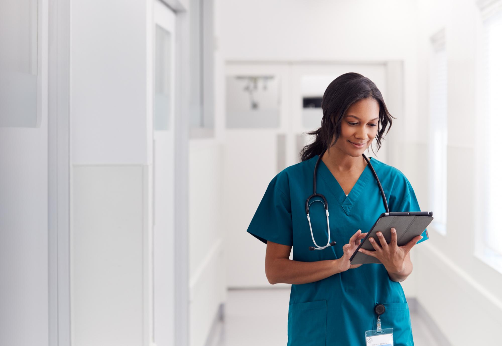 Female health professional using tablet computer