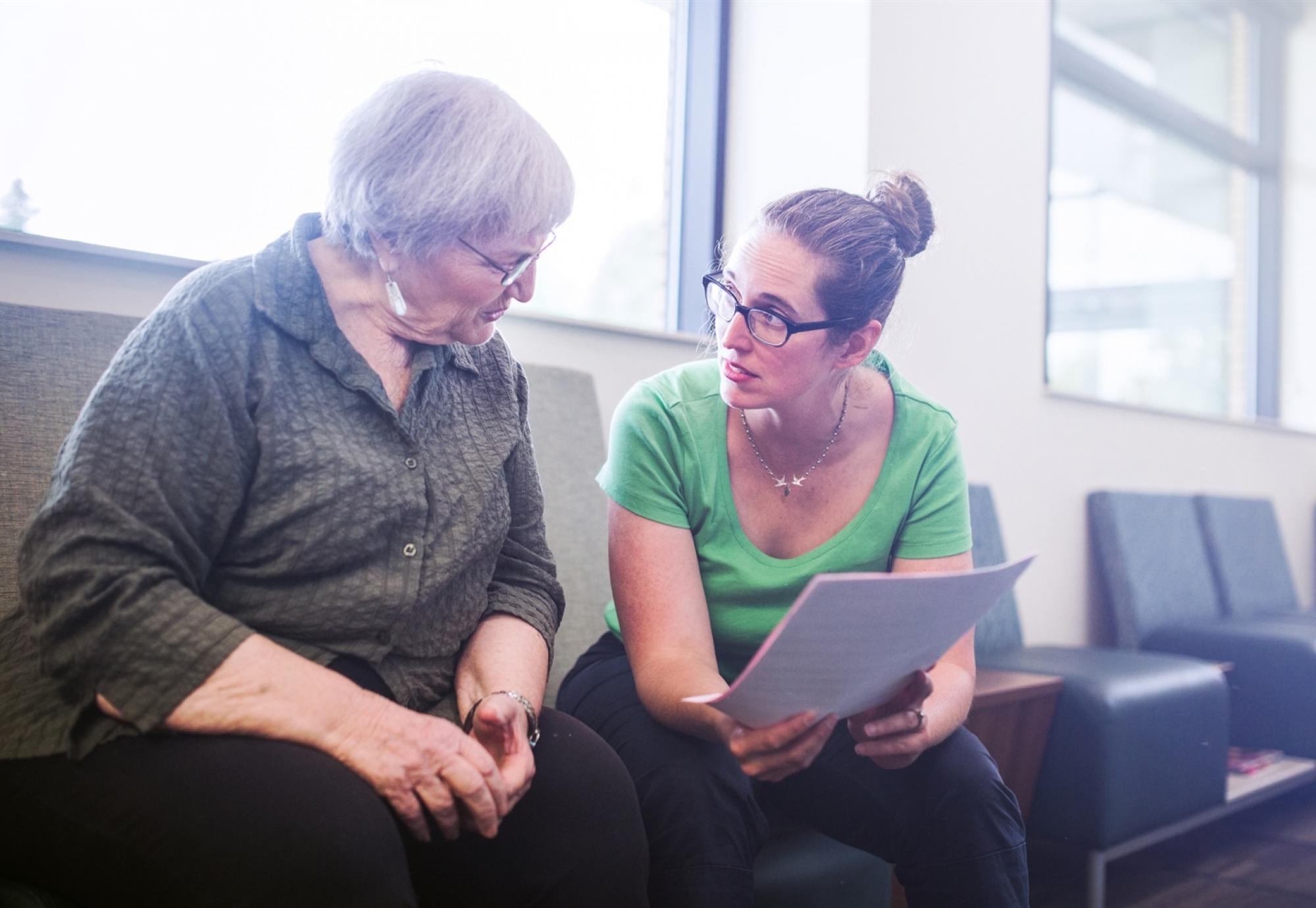 Woman supporting elderly patient