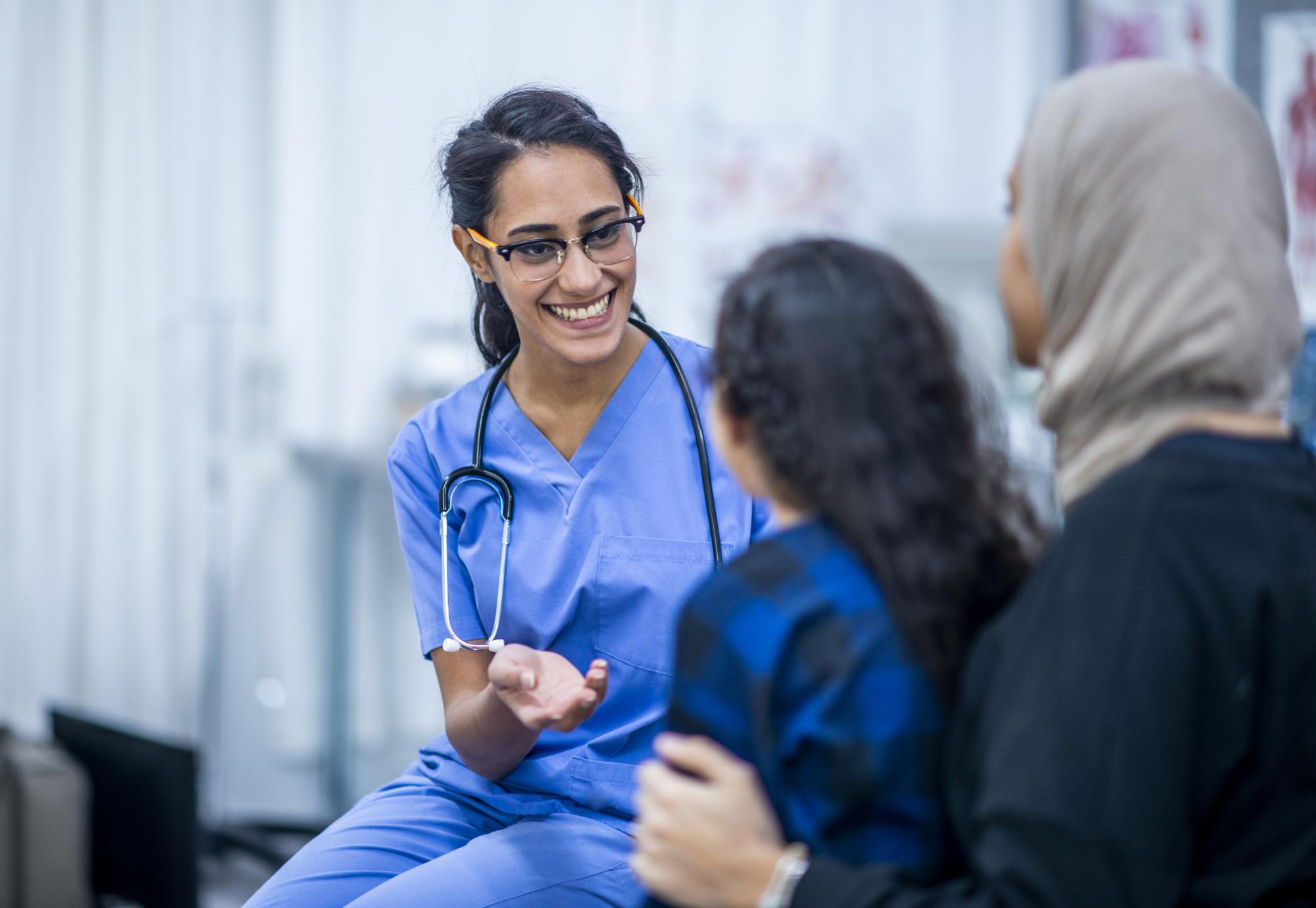 Female health professional seeing to a young female patient