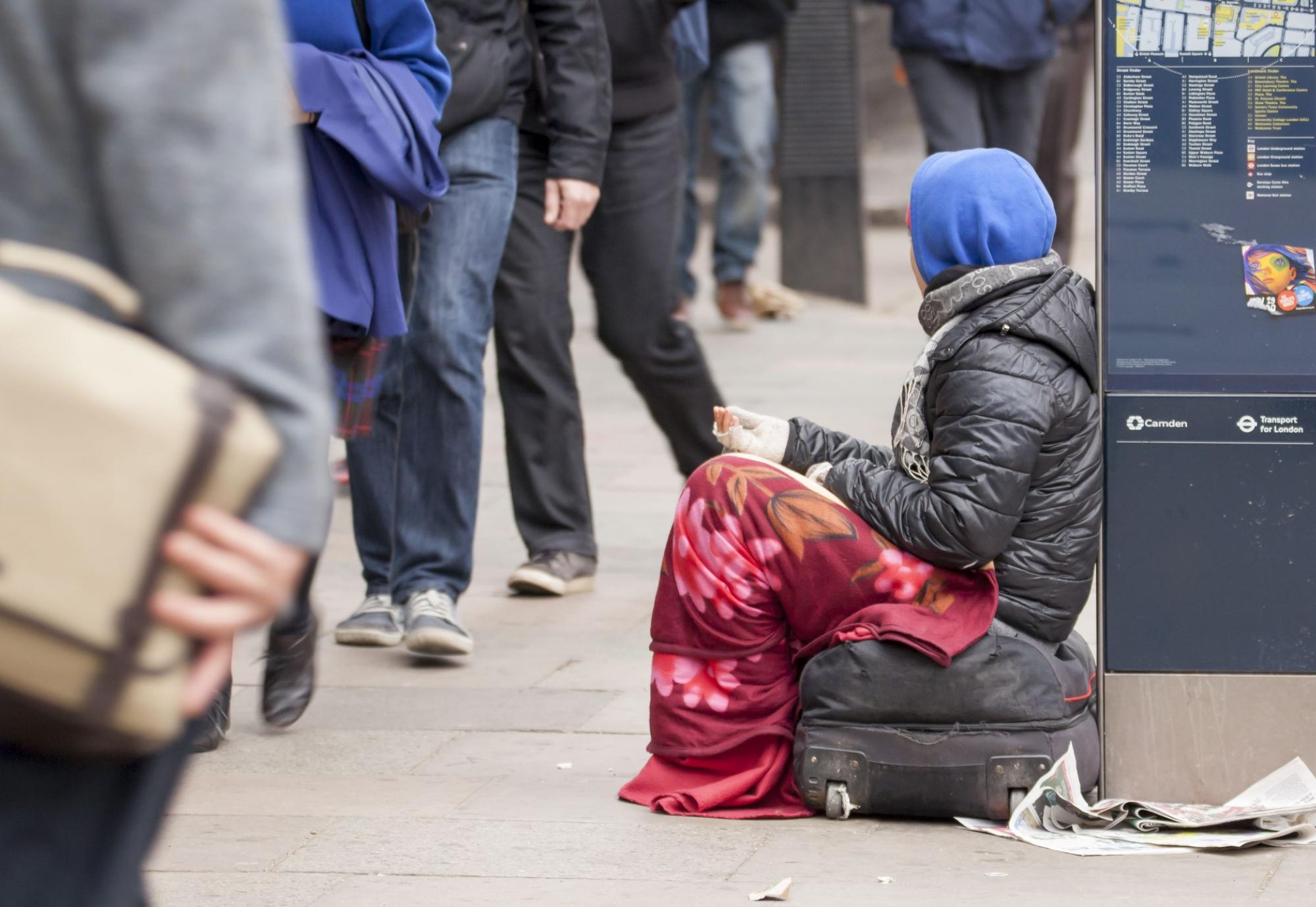 Homeless female sat asking for spare change 