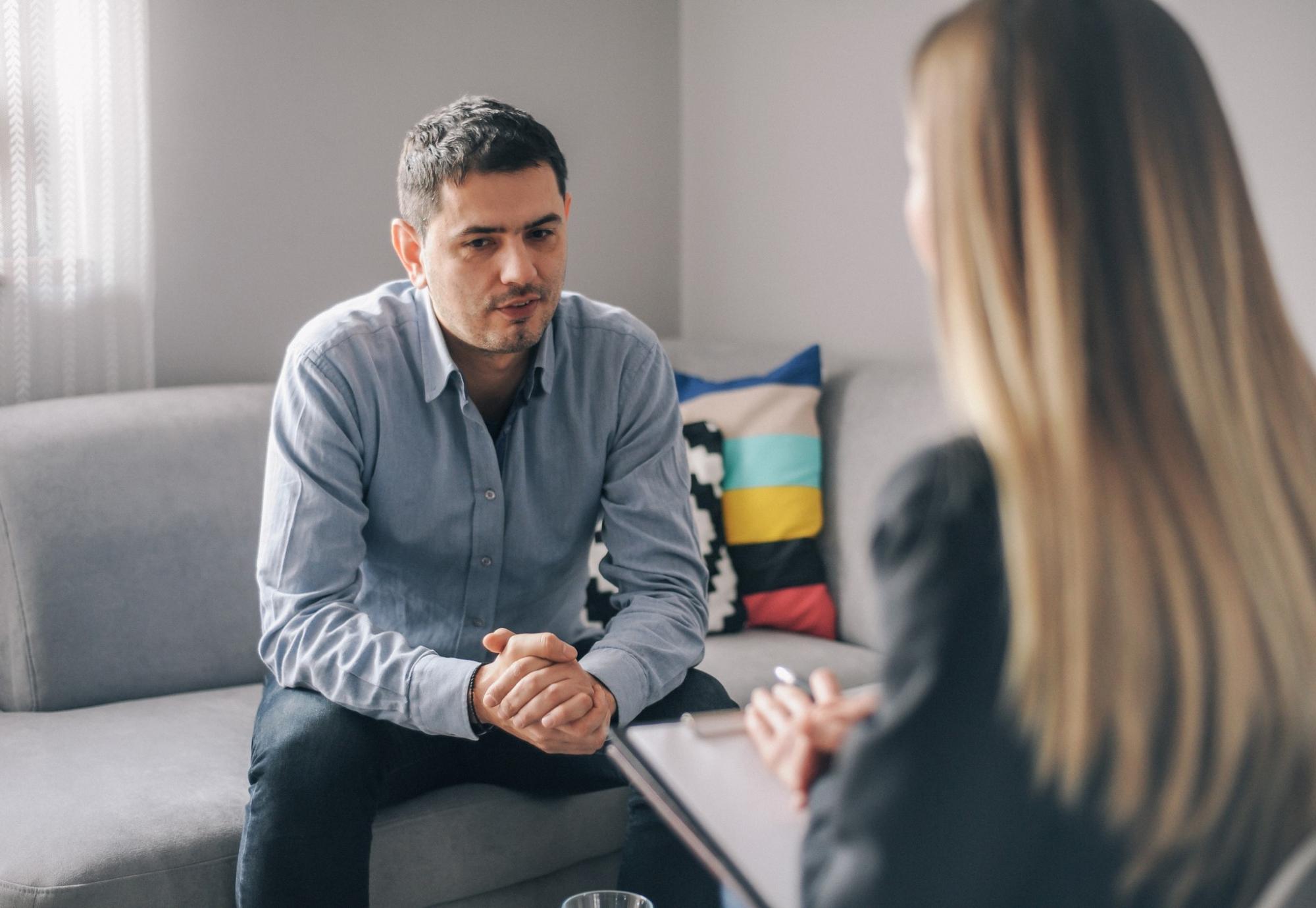 Female psychiatrist talking with male patient