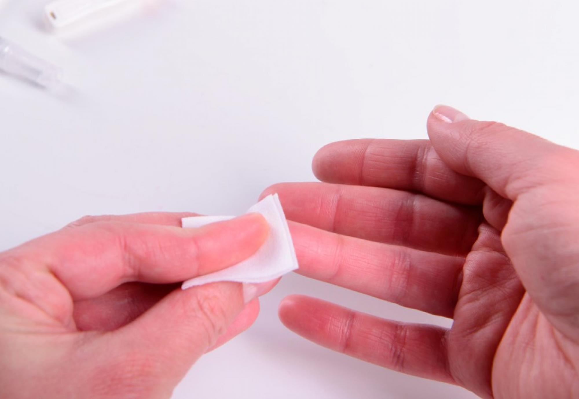 A person holding tissue on their finger 