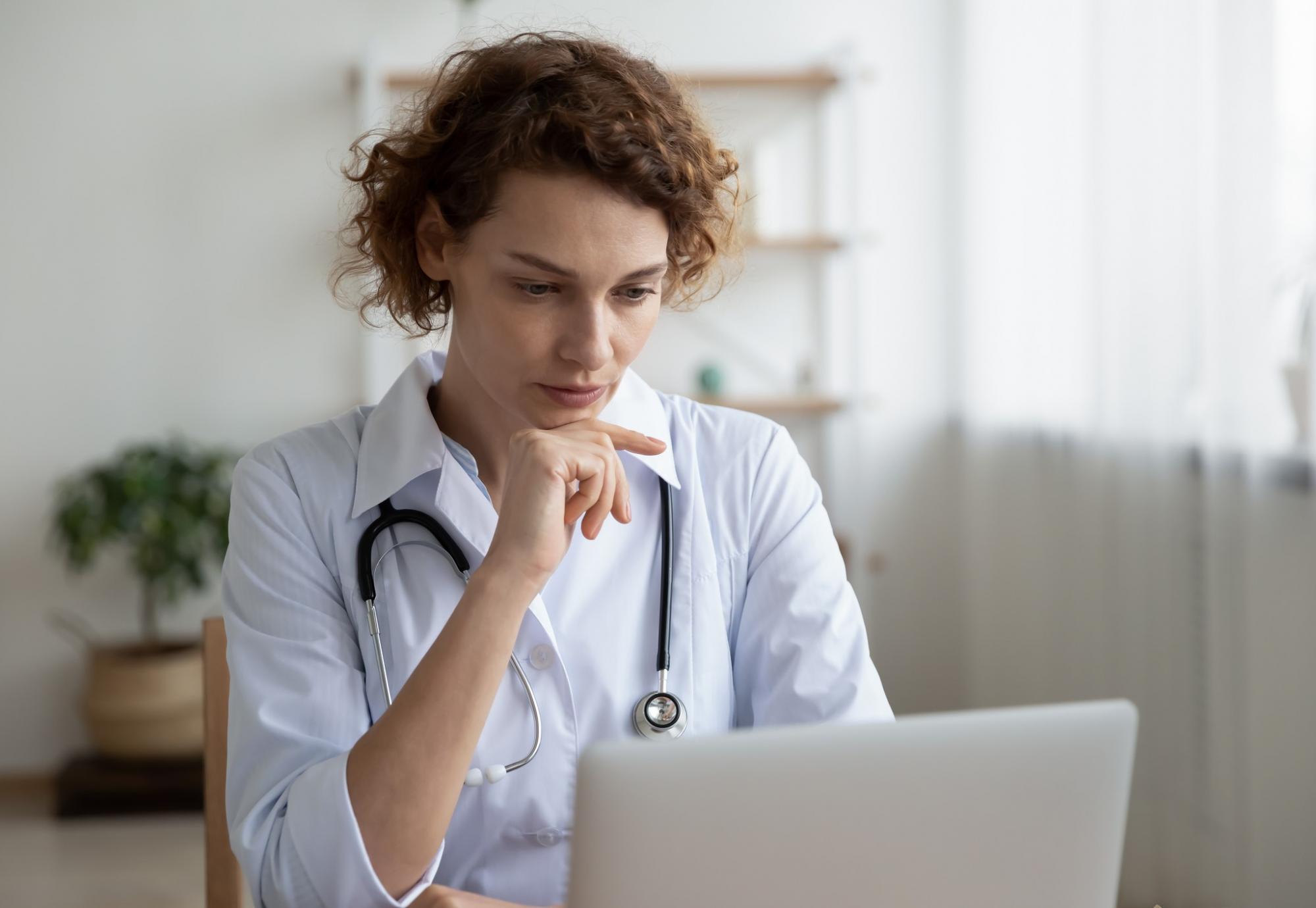 Health professional at a laptop