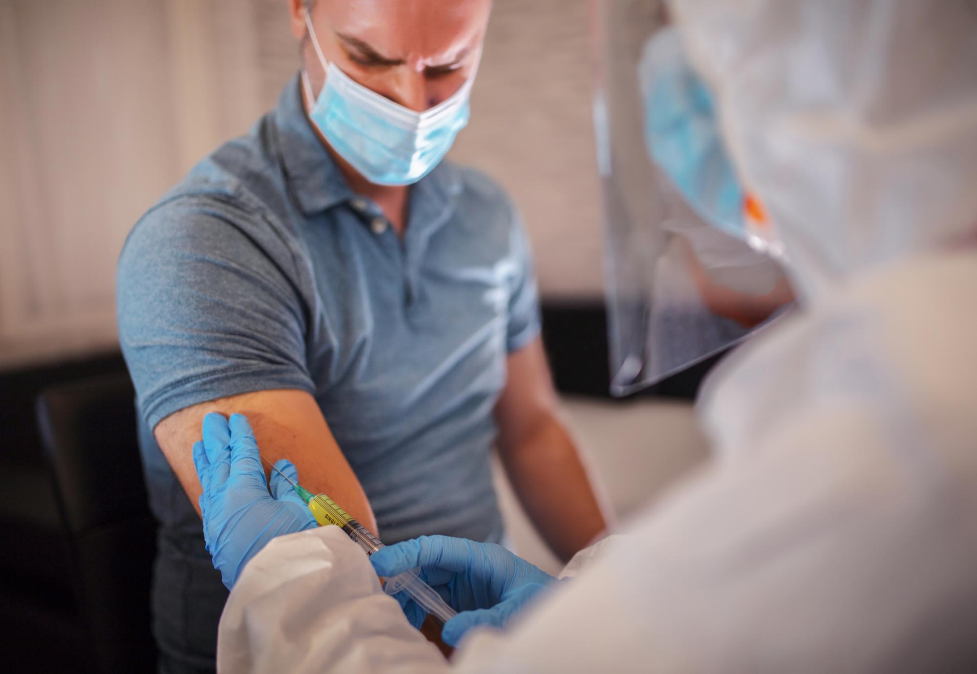 Male patient receiving a flu vaccination