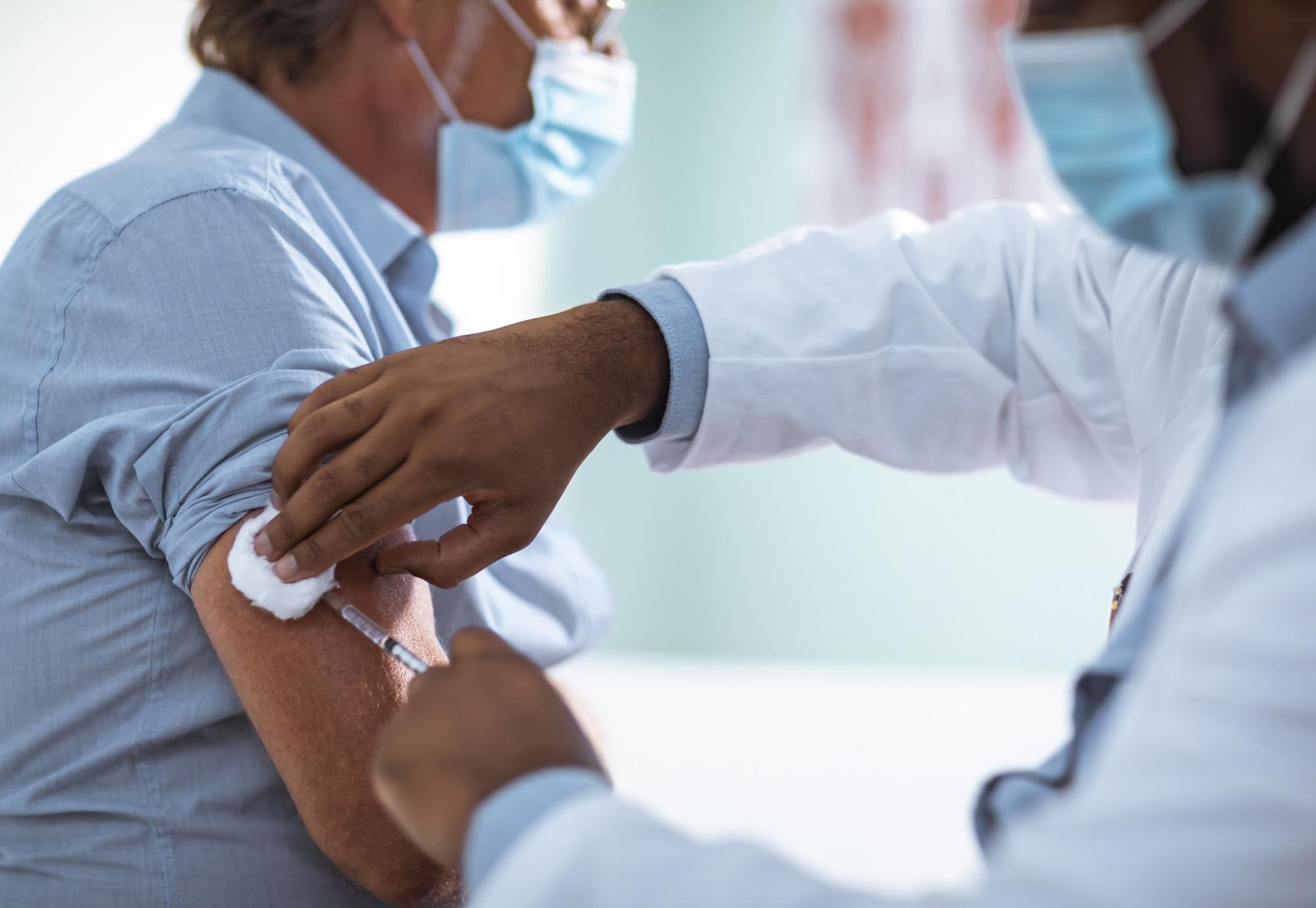 Male patient being administered a vaccine