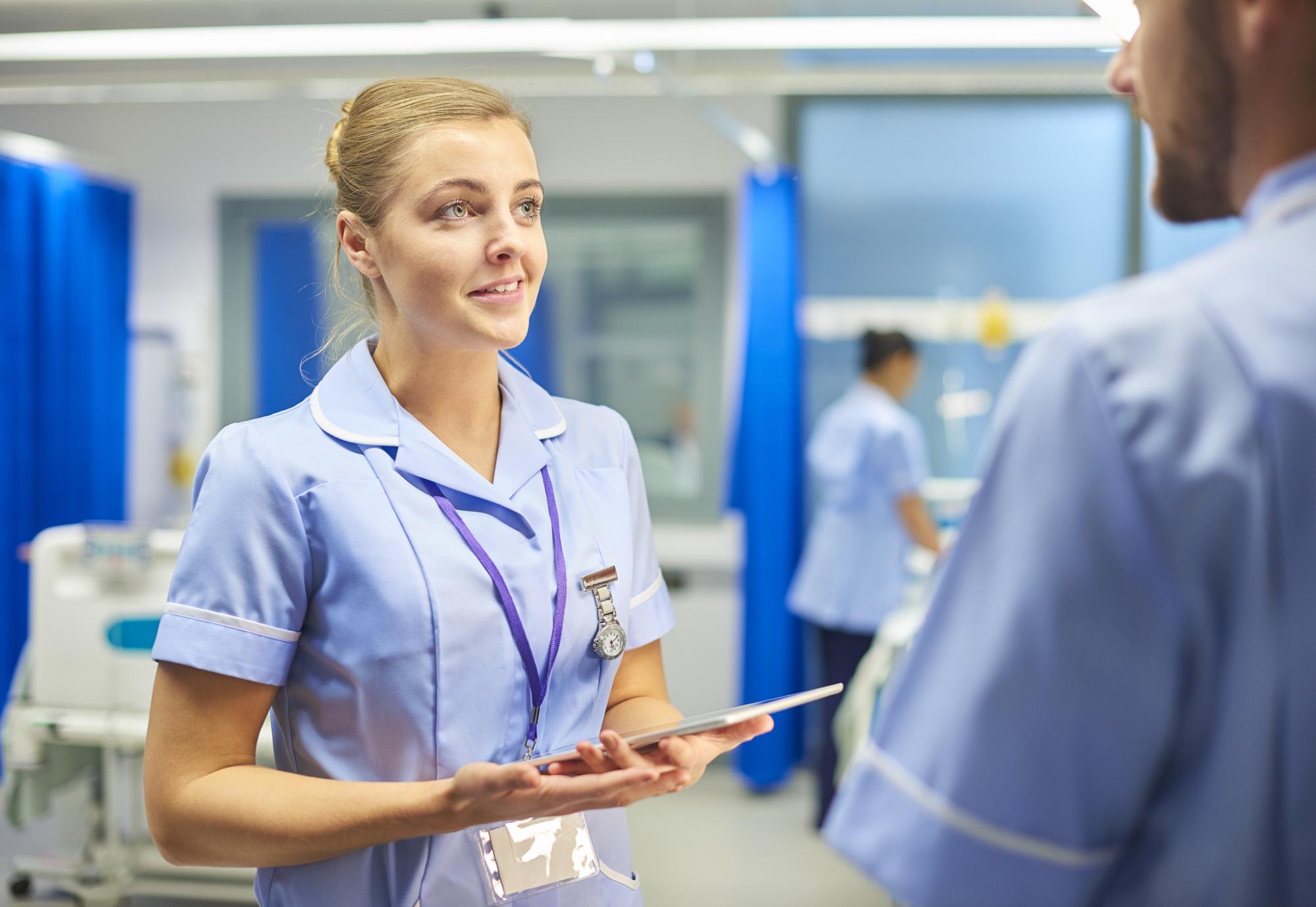 Female nurse in discussion with a colleague