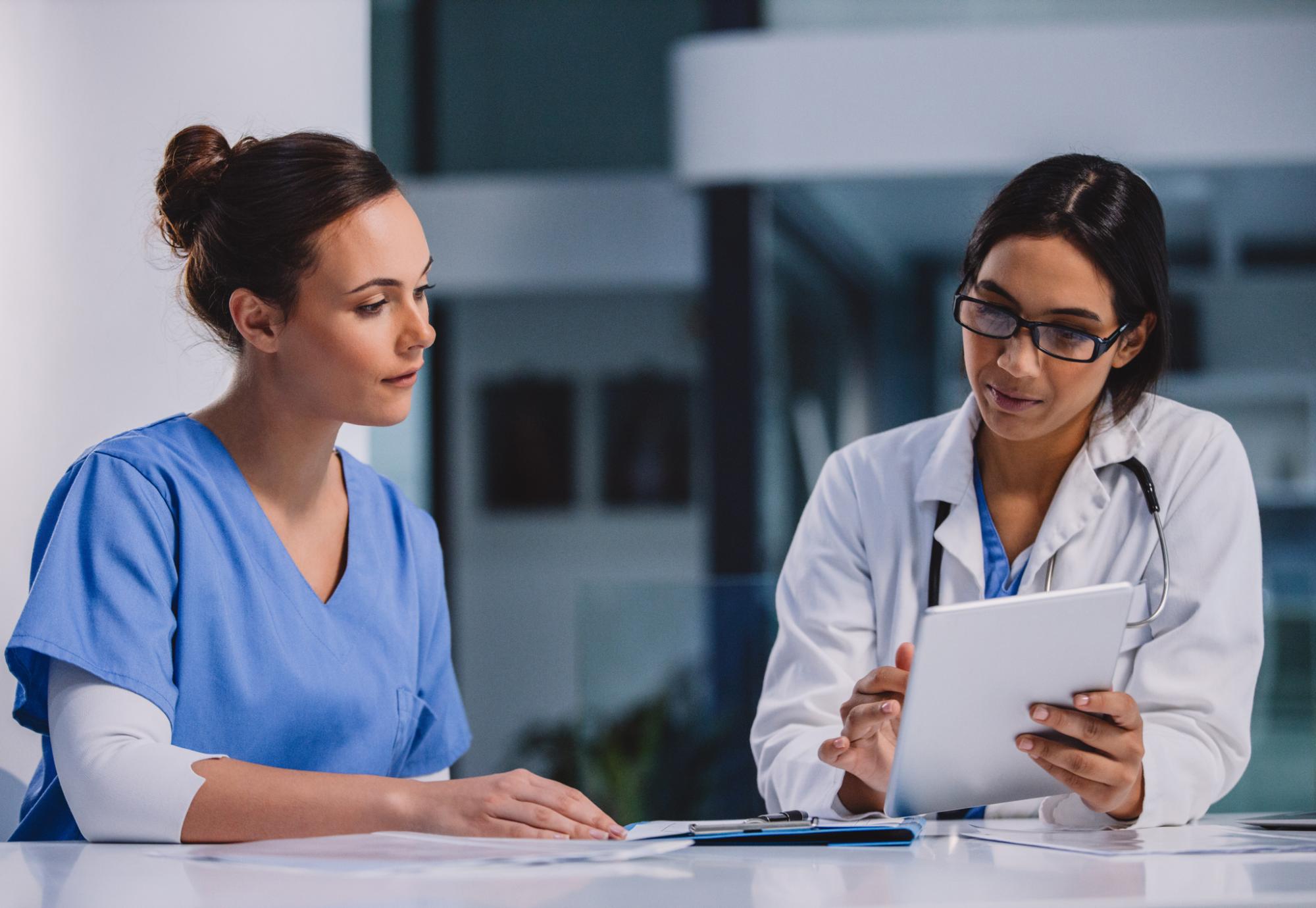 Senior nurse discusses problems with nurse