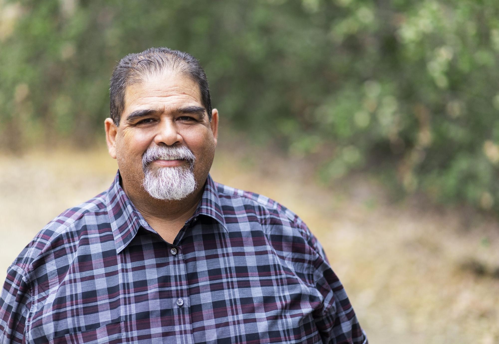 Overweight man smiling at the camera