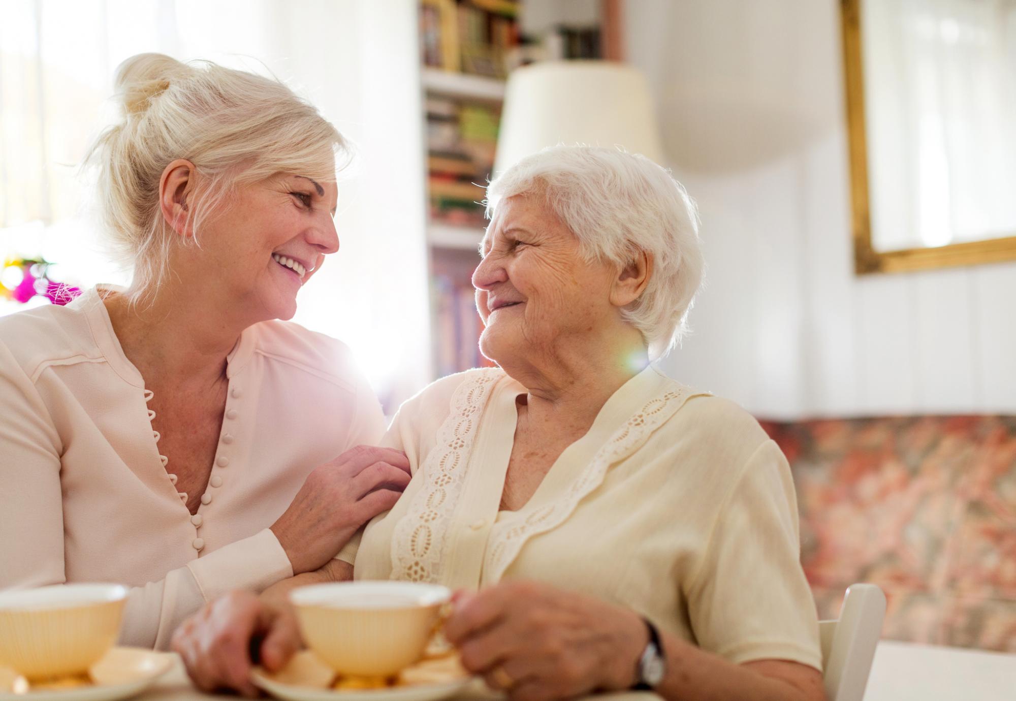 Woman supporting an elderly relative, in conversation