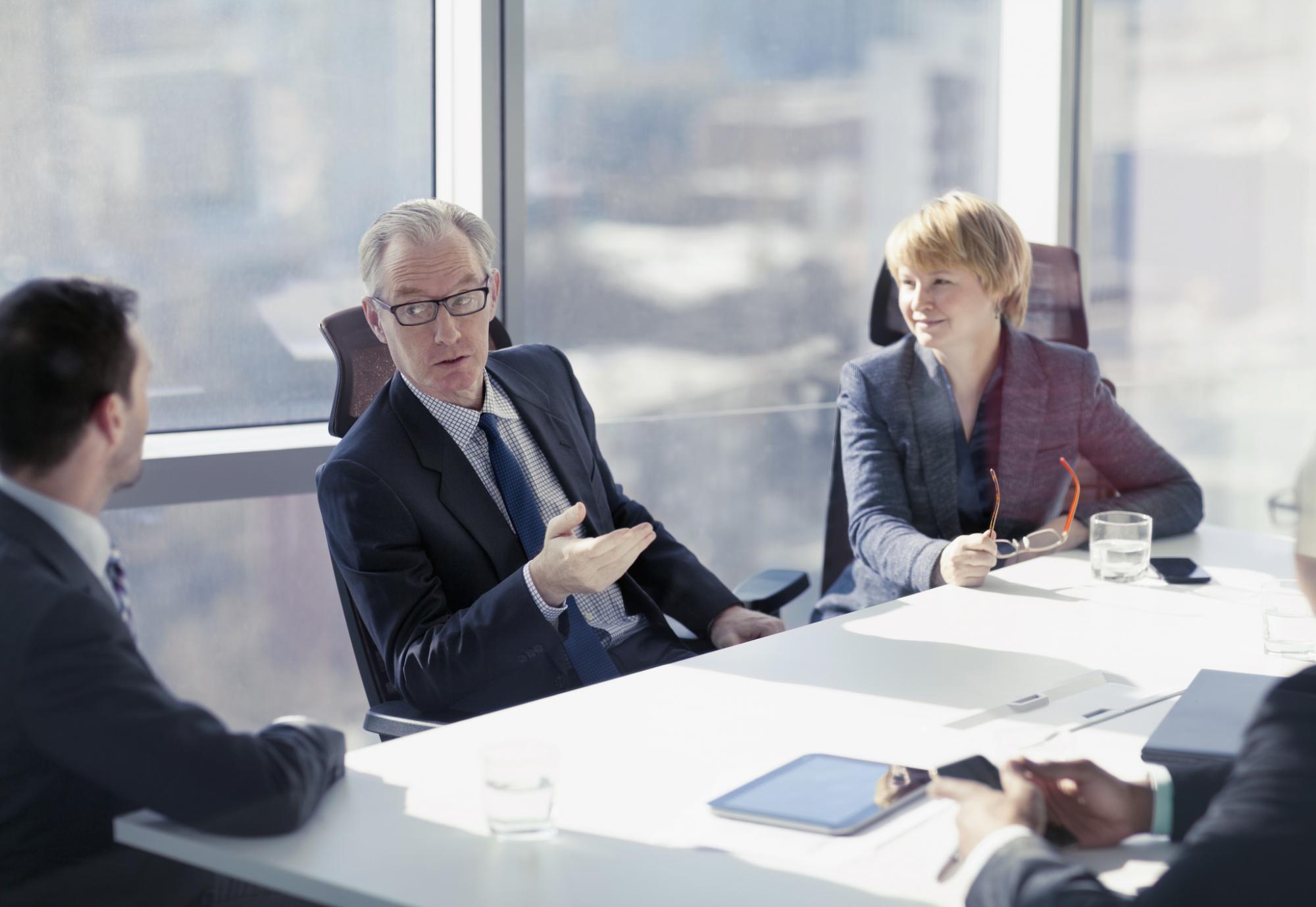 Discussion during a board meeting, soft focus background