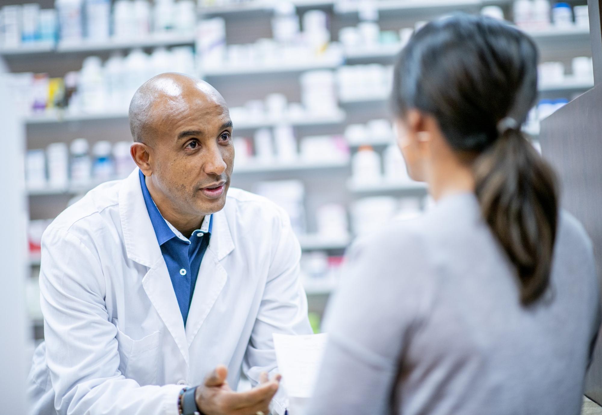 Community pharmacist in discussion with a patient