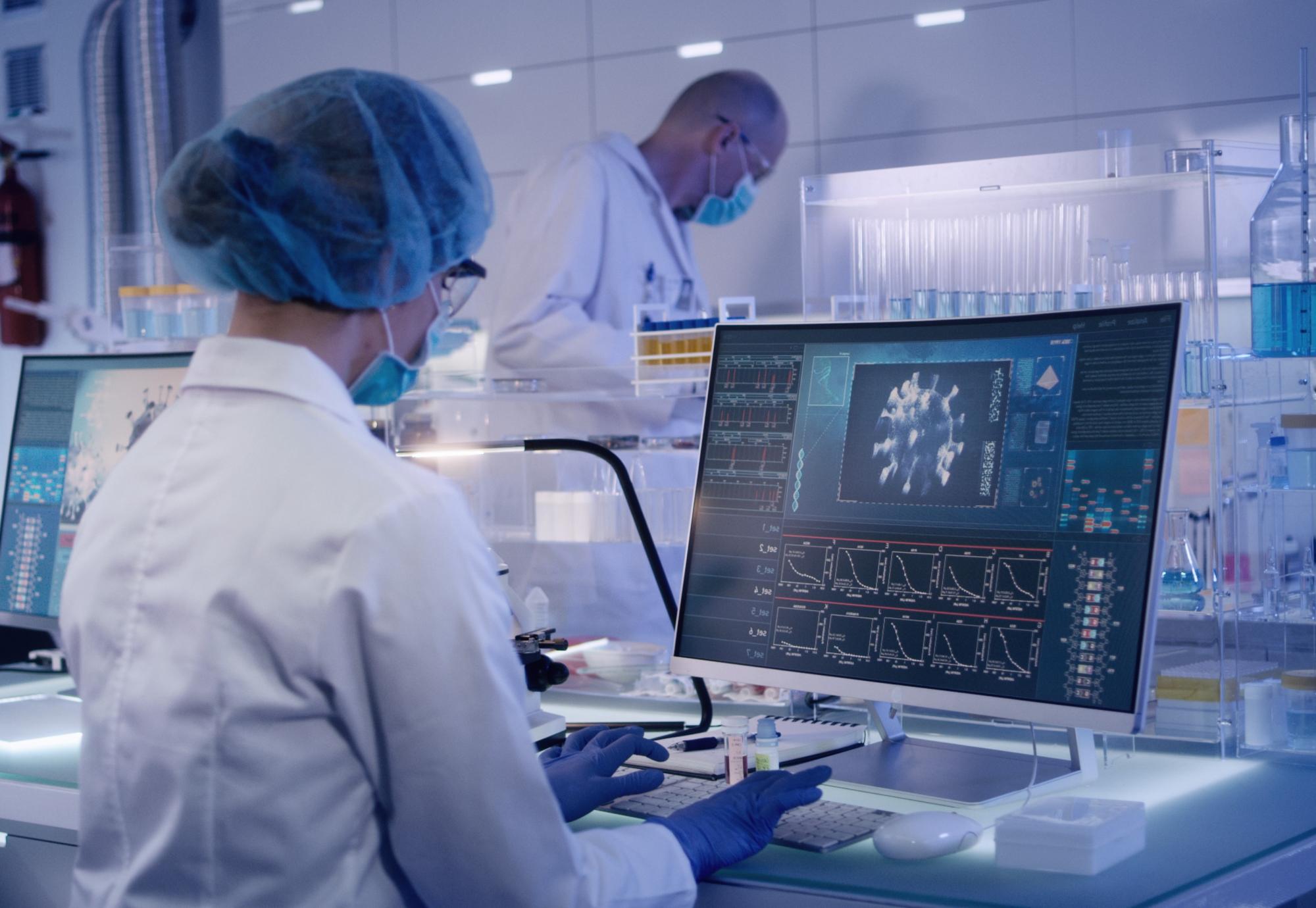 Lab technician operating a computer reviewing data