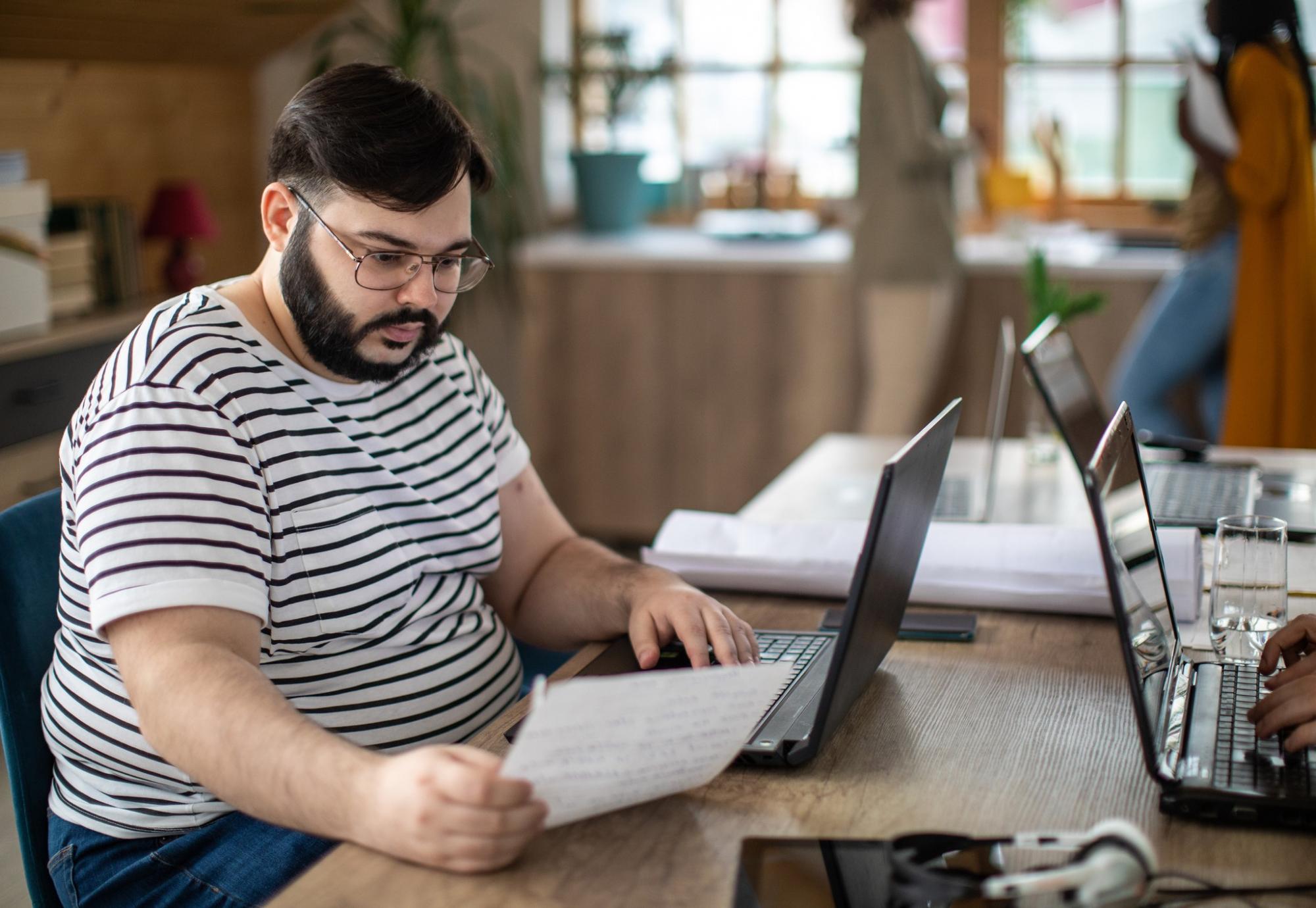 Overweight man at a laptop working