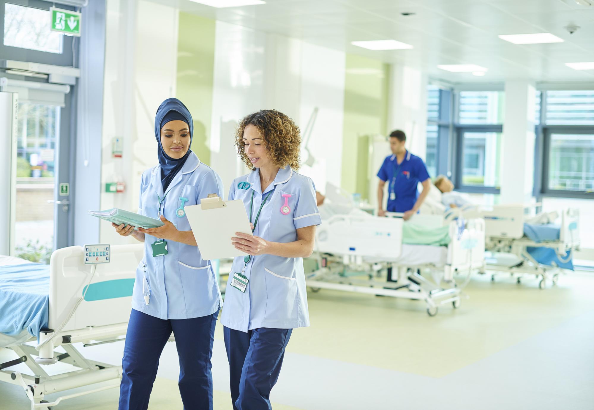 Female health professionals discussing during a ward round